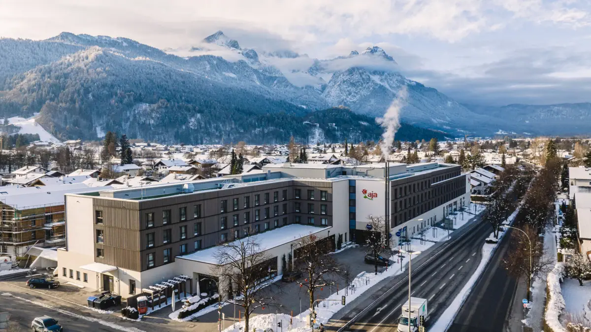 A building with snow by the roadside.