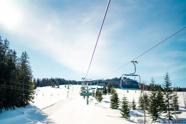 Ski lift with trees and snow in winter.