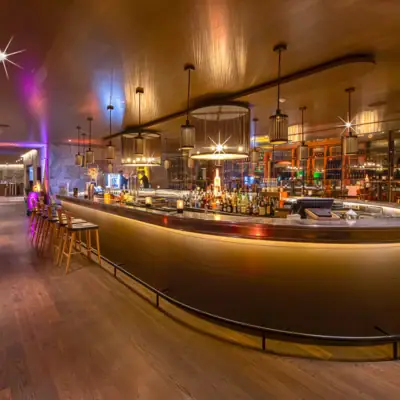 A bar with a counter and stools.