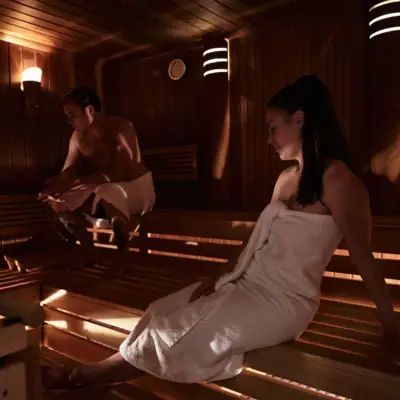 A man and a woman in a sauna.