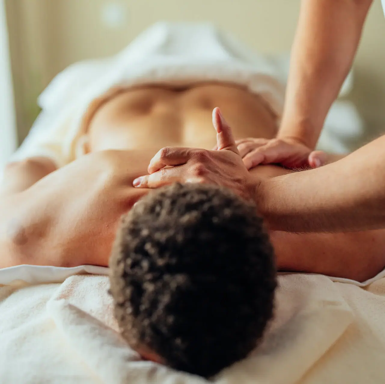 A man is lying on a massage table.