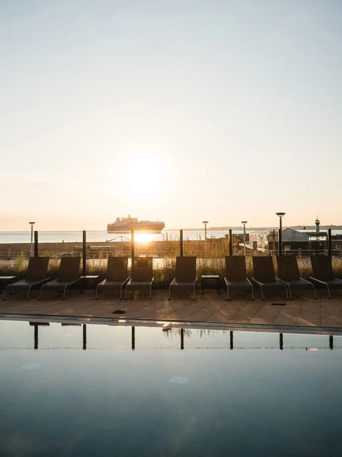 A row of chairs by the outdoor pool.