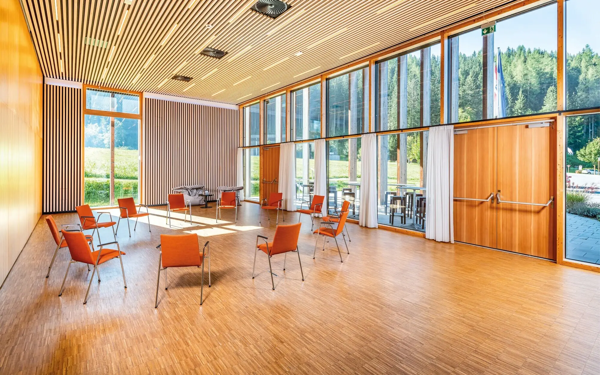 Meeting room with large floor-to-ceiling windows and a circle of chairs.