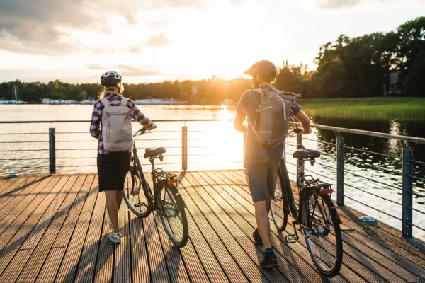 Cycling on Lake Scharmützelsee Two people with bicycles on a jetty by the lake.