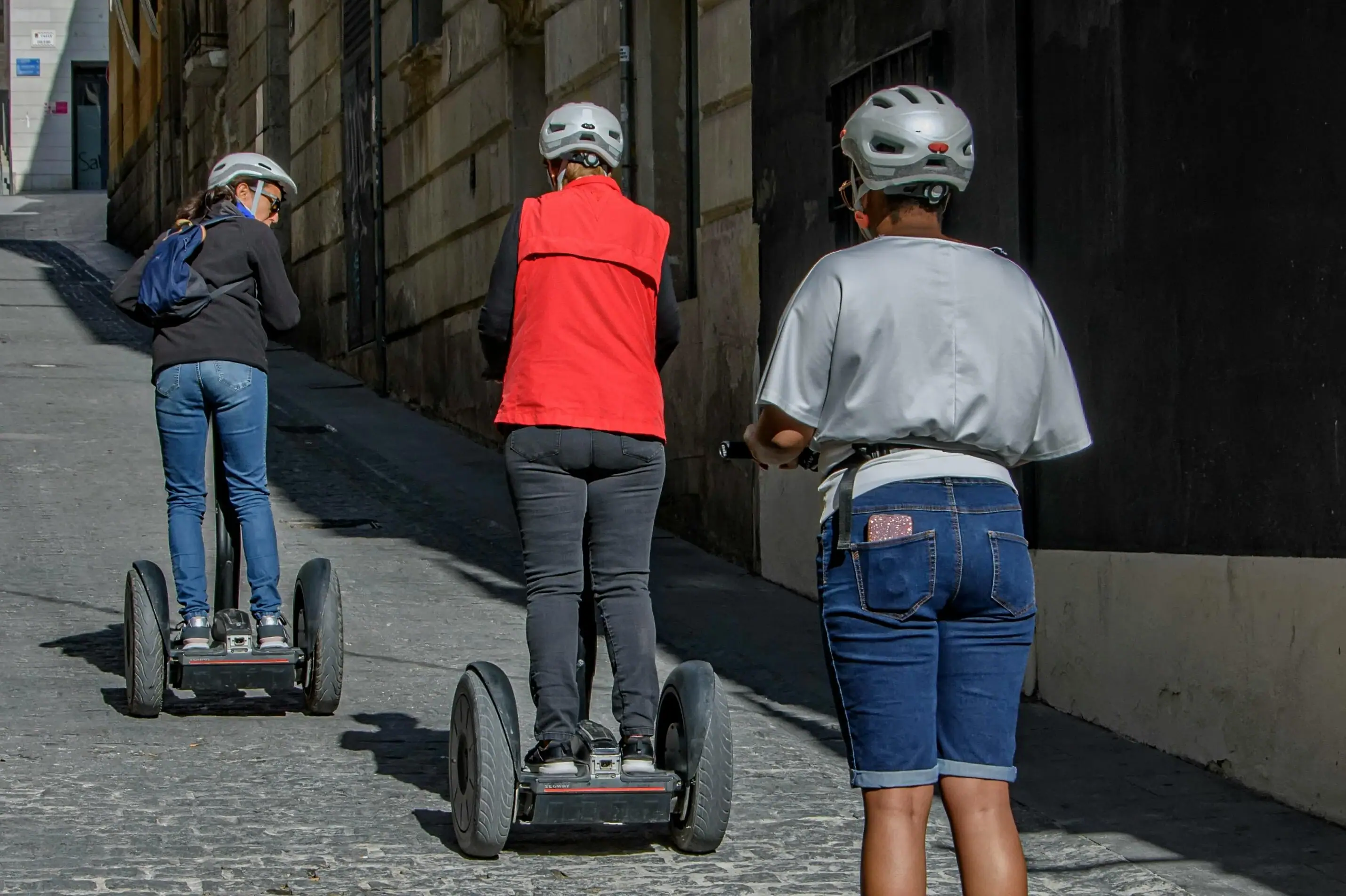 A group of people ride a Segway.