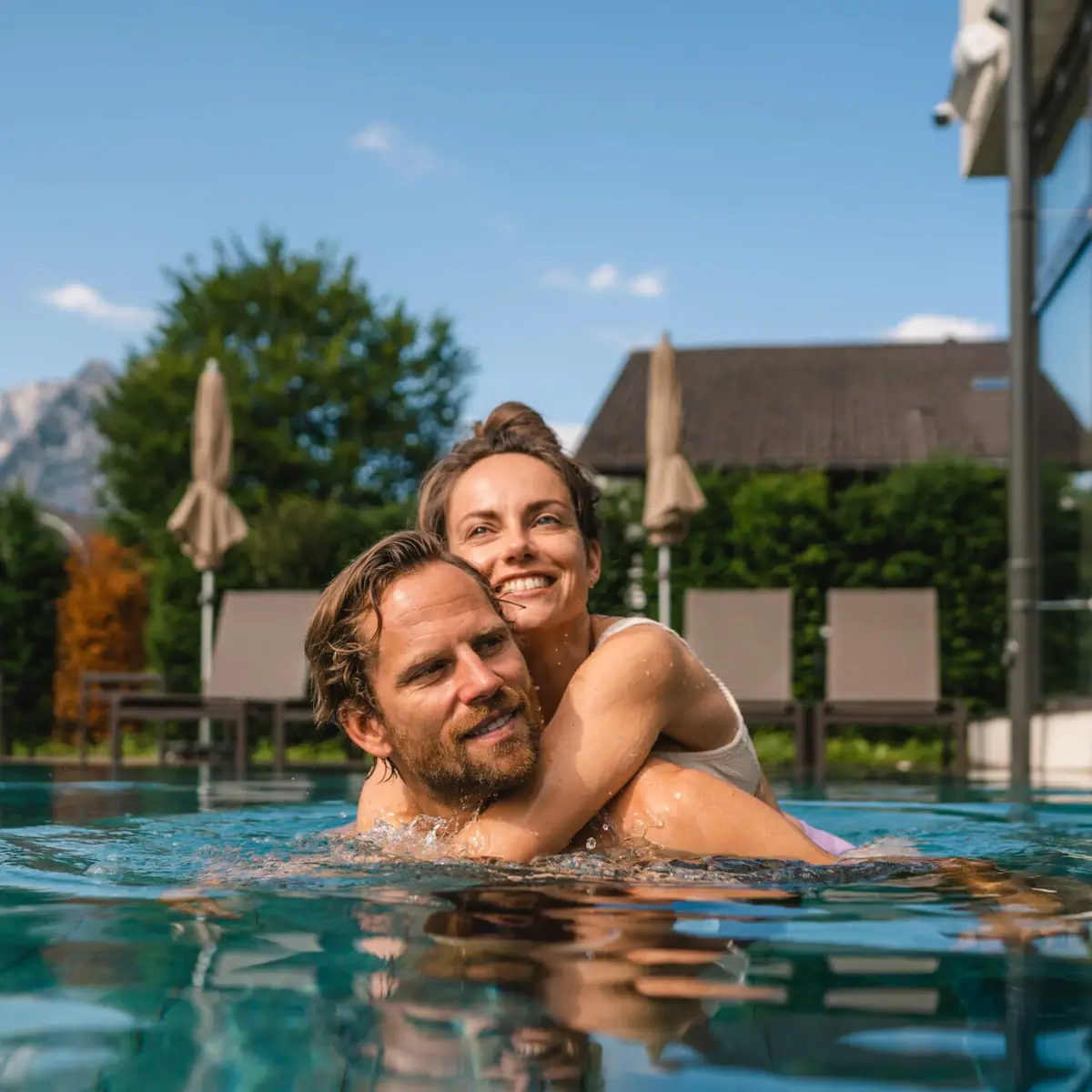 Outdoor pool aja Garmisch Partenkirchen A man and a woman in the pool, both smiling.