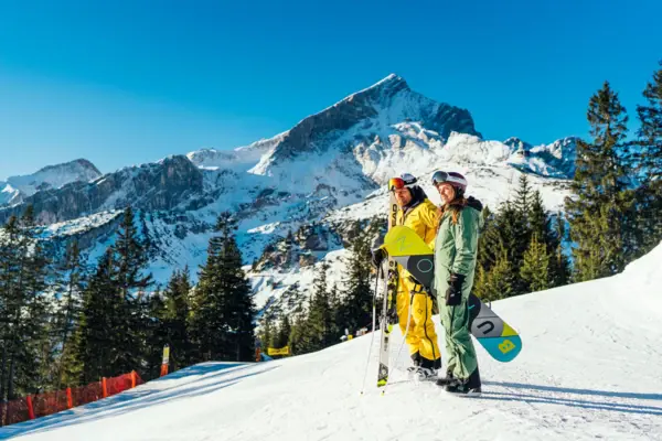 Ski holiday Two people in snow clothing on a snow-covered mountain.
