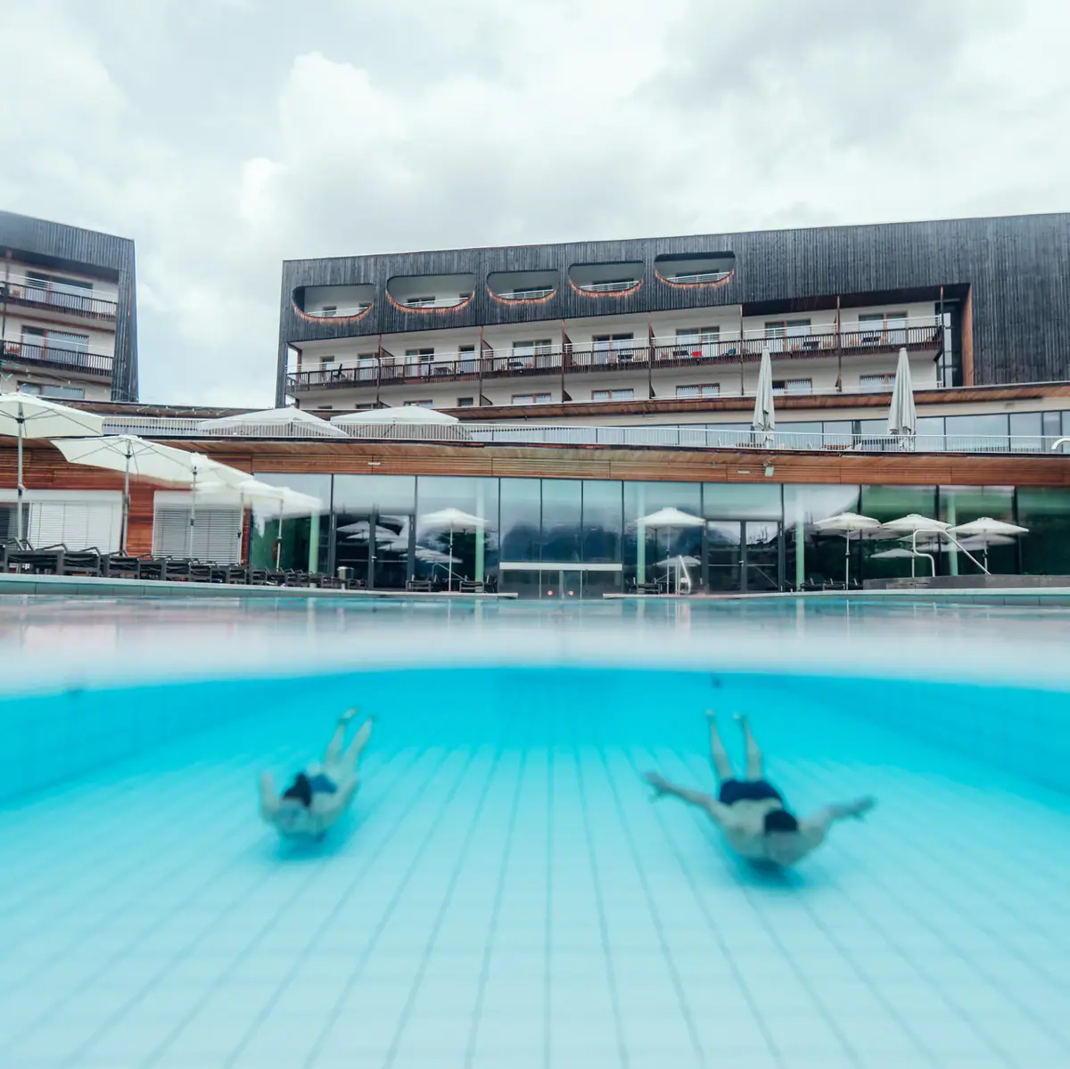 People are swimming in a pool.