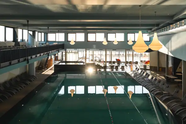 Indoor pool with blue water and ceiling in the background