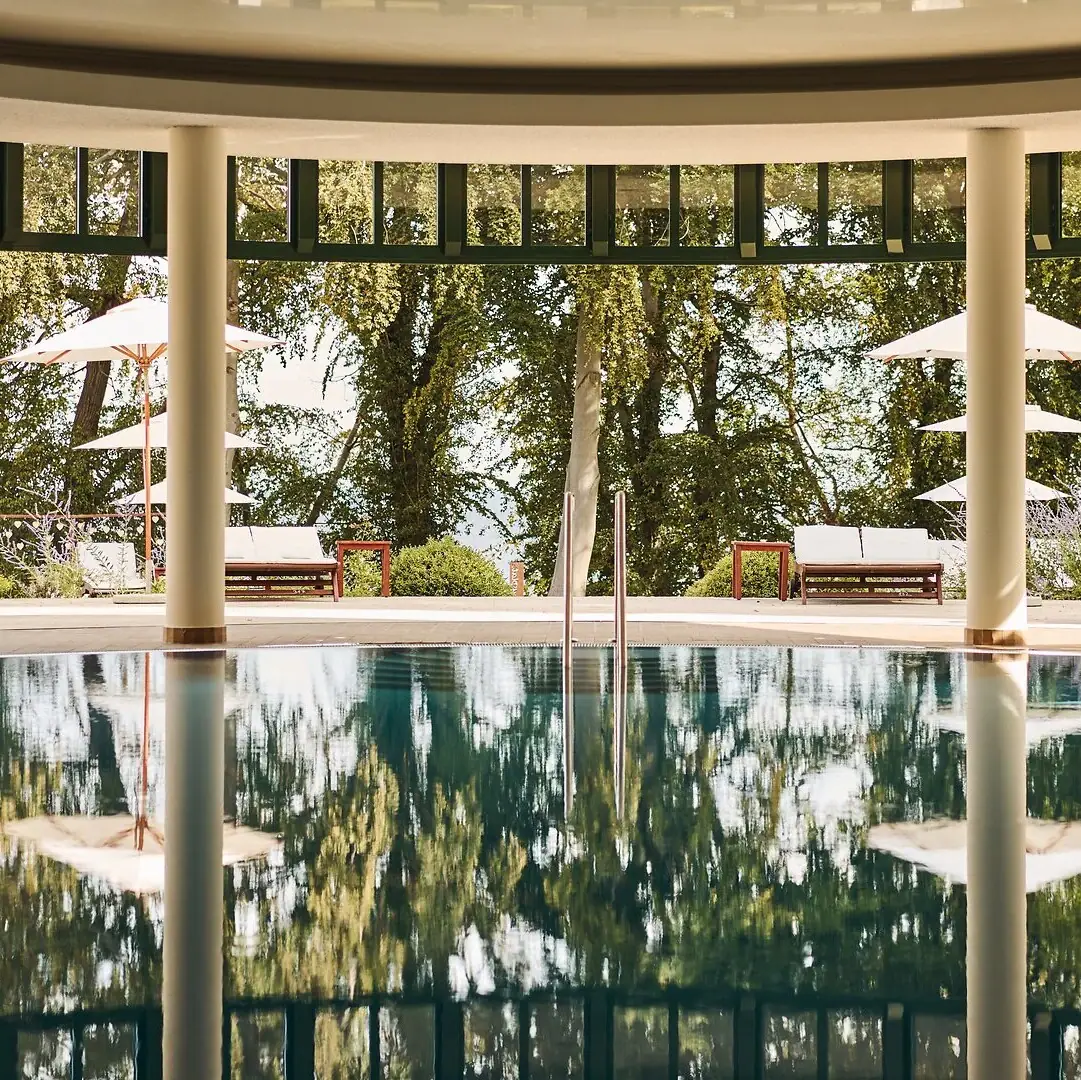 Indoor pool aja Nordperd & Villas A pool with parasols and chairs in the background.