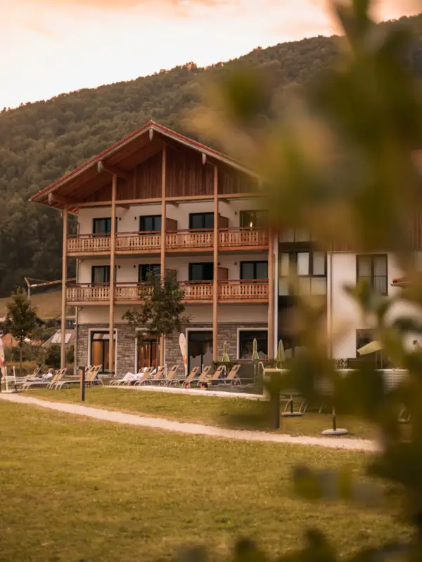 aja Ruhpolding A building with a lawn and chairs in front of it.