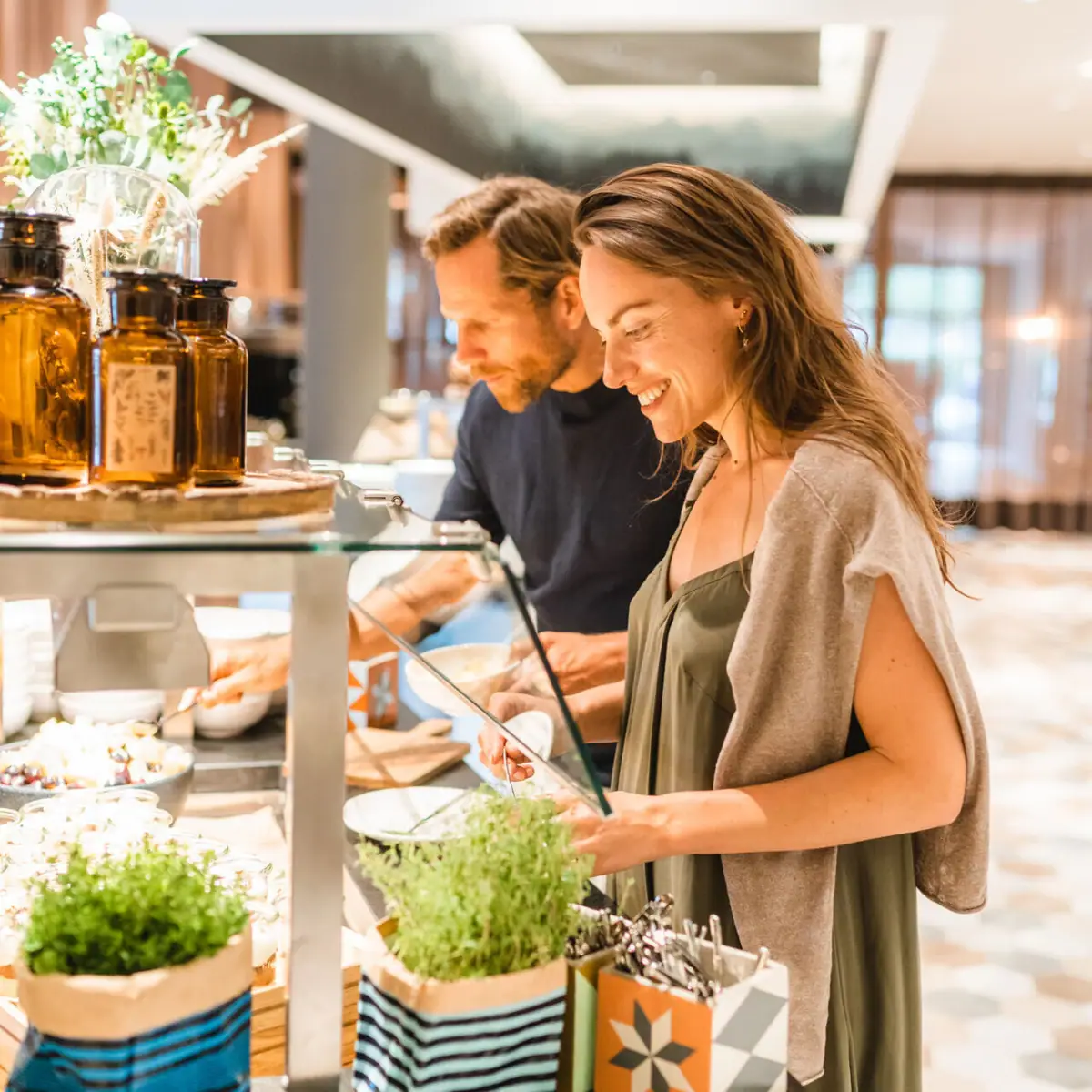 Buffet A man and a woman stand in front of a glass display case.