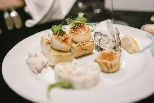A plate of food, various snacks such as scallops.