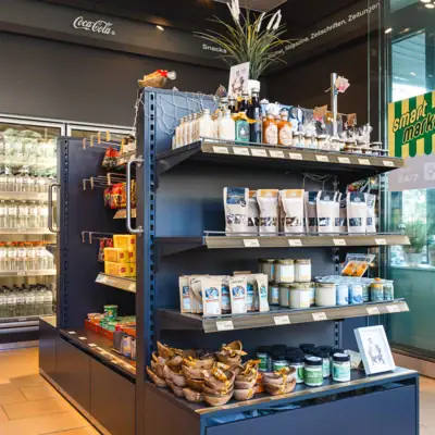 Retail shop with shelves full of food and drinks.