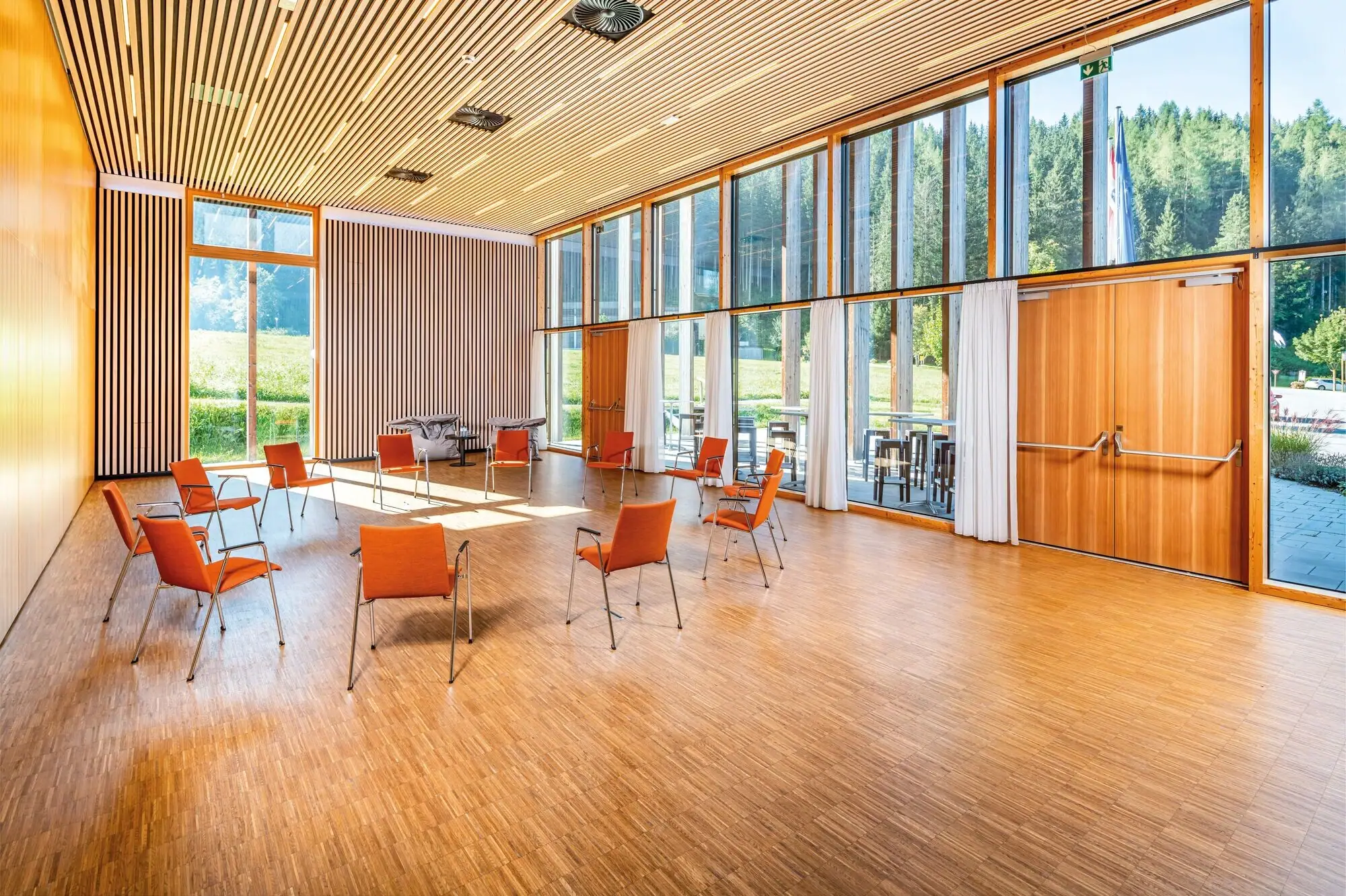 Campus conference room Meeting room with large floor-to-ceiling windows and a circle of chairs.