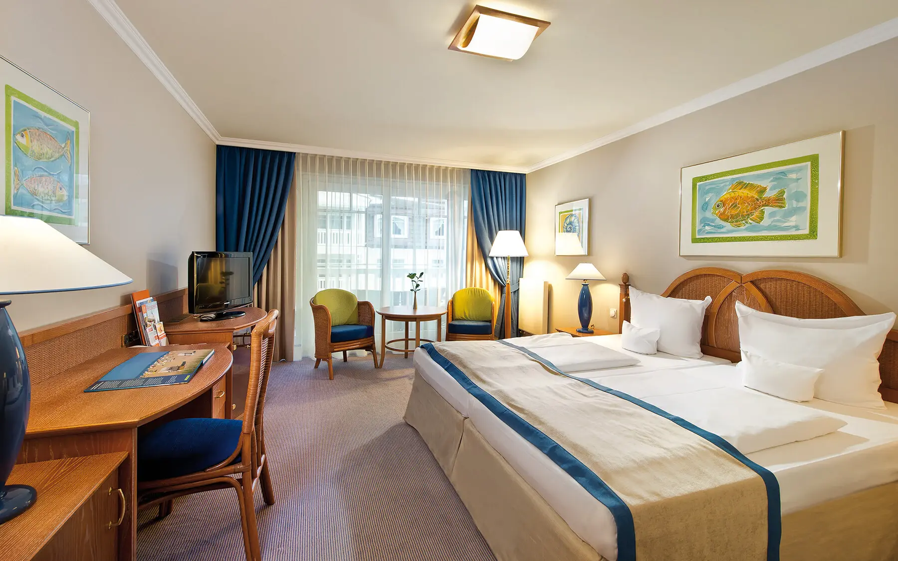 An inviting hotel room with a cosy bed, bedside tables and a desk corner.