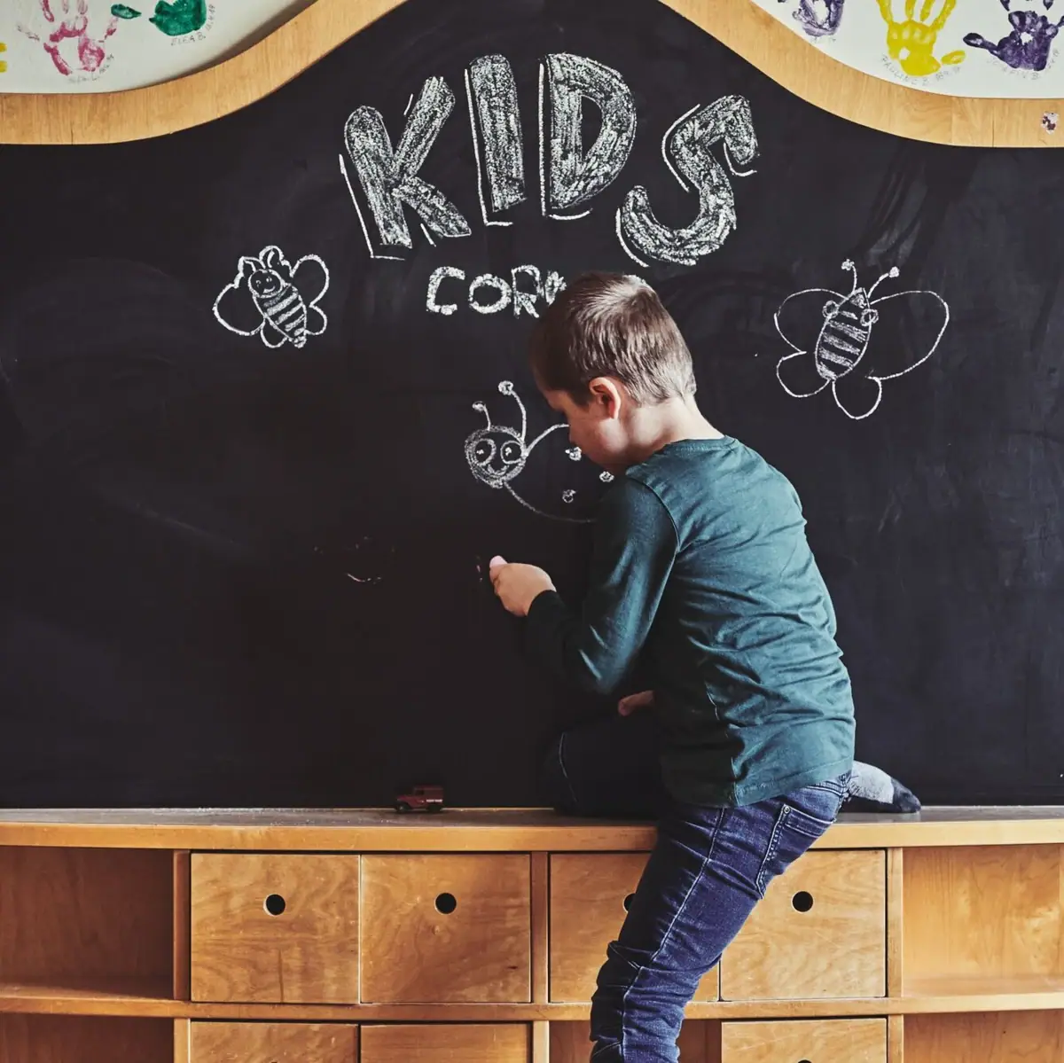 A boy writes on a blackboard.