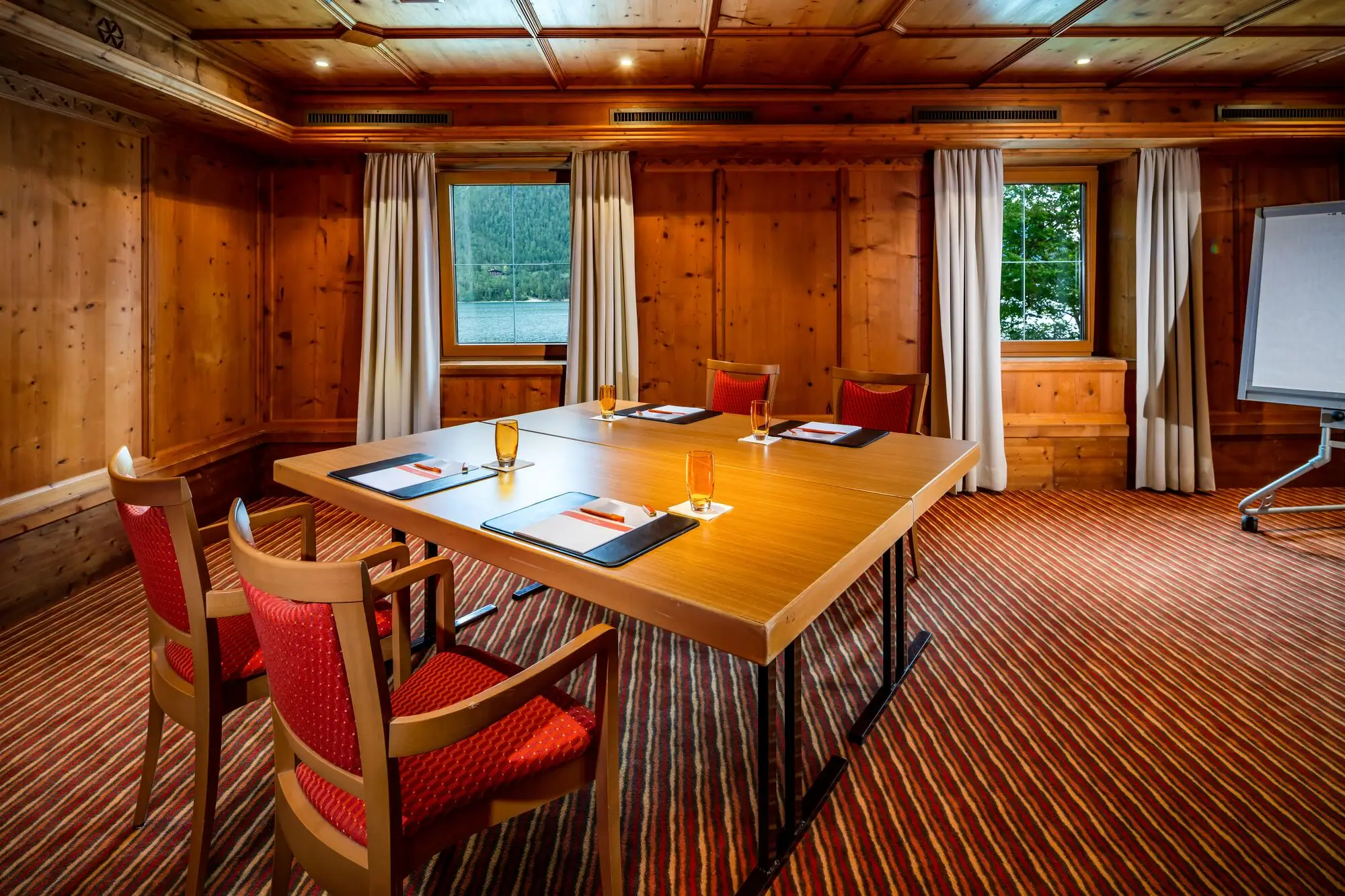 Meeting room with a table block and four chairs.