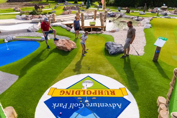 A group of people playing golf.