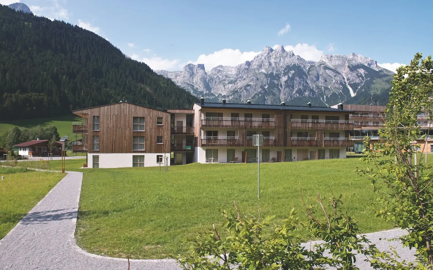 aja vacation apartments in Werfenweng with lawn and mountain scenery in the background.