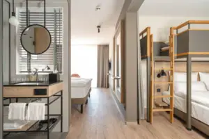 Family room A room with a bunk bed and a mirror.