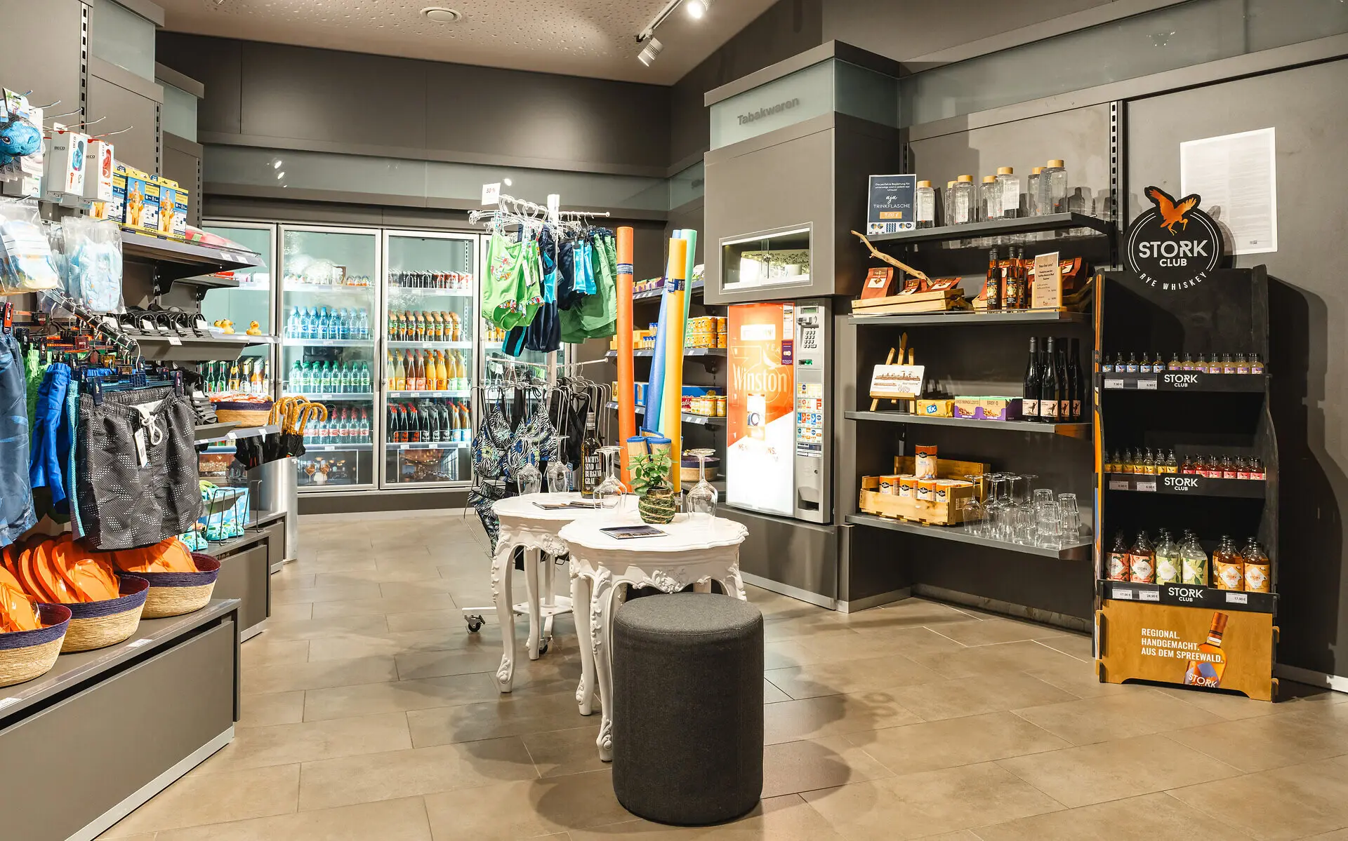 Interior of a store filled with shelves stocked with various drinks.