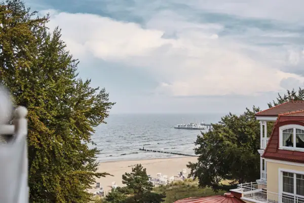 A beach with a boat in the water.