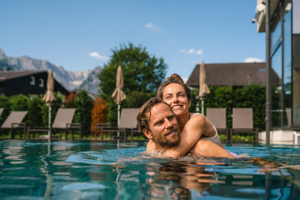 Outdoor pool A man and a woman in the pool, both smiling.