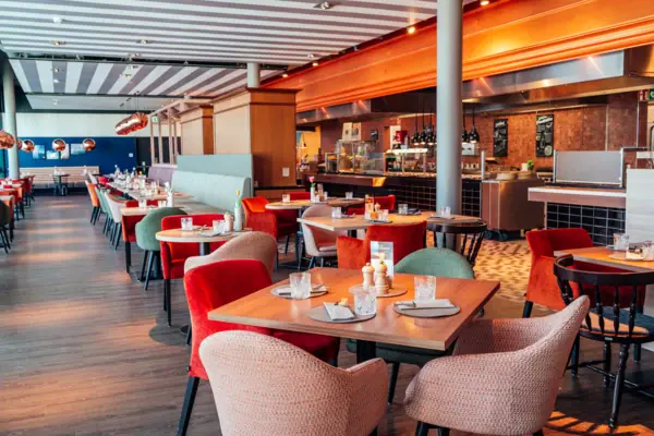 A restaurant with tables and chairs.