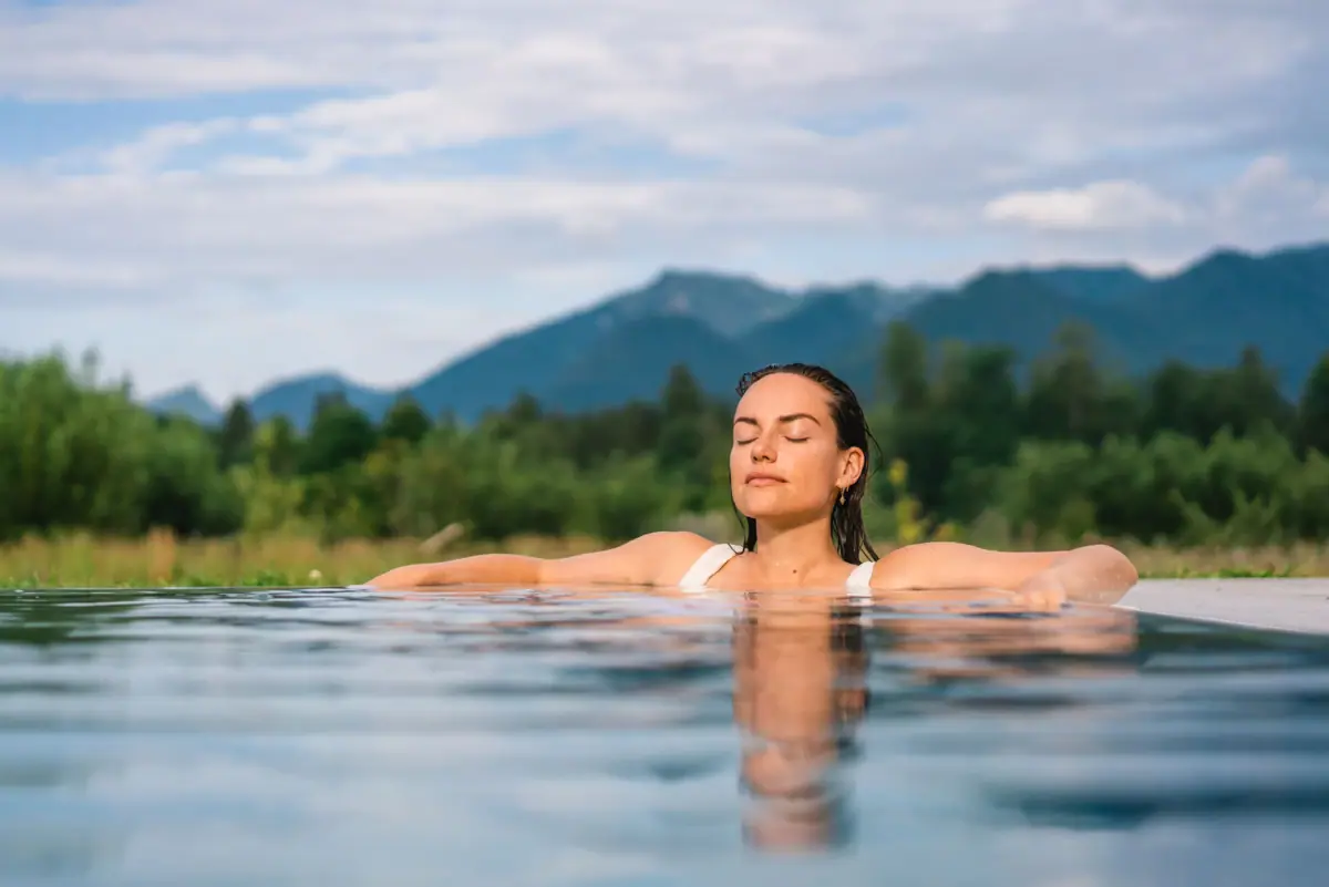 Outdoor swimming pool A woman with her eyes closed in the pool at a spa hotel in Bavaria.