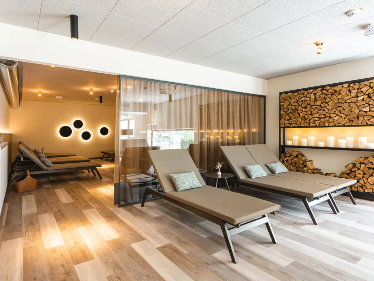 Relaxation room A room with lounge chairs and wooden shelves.