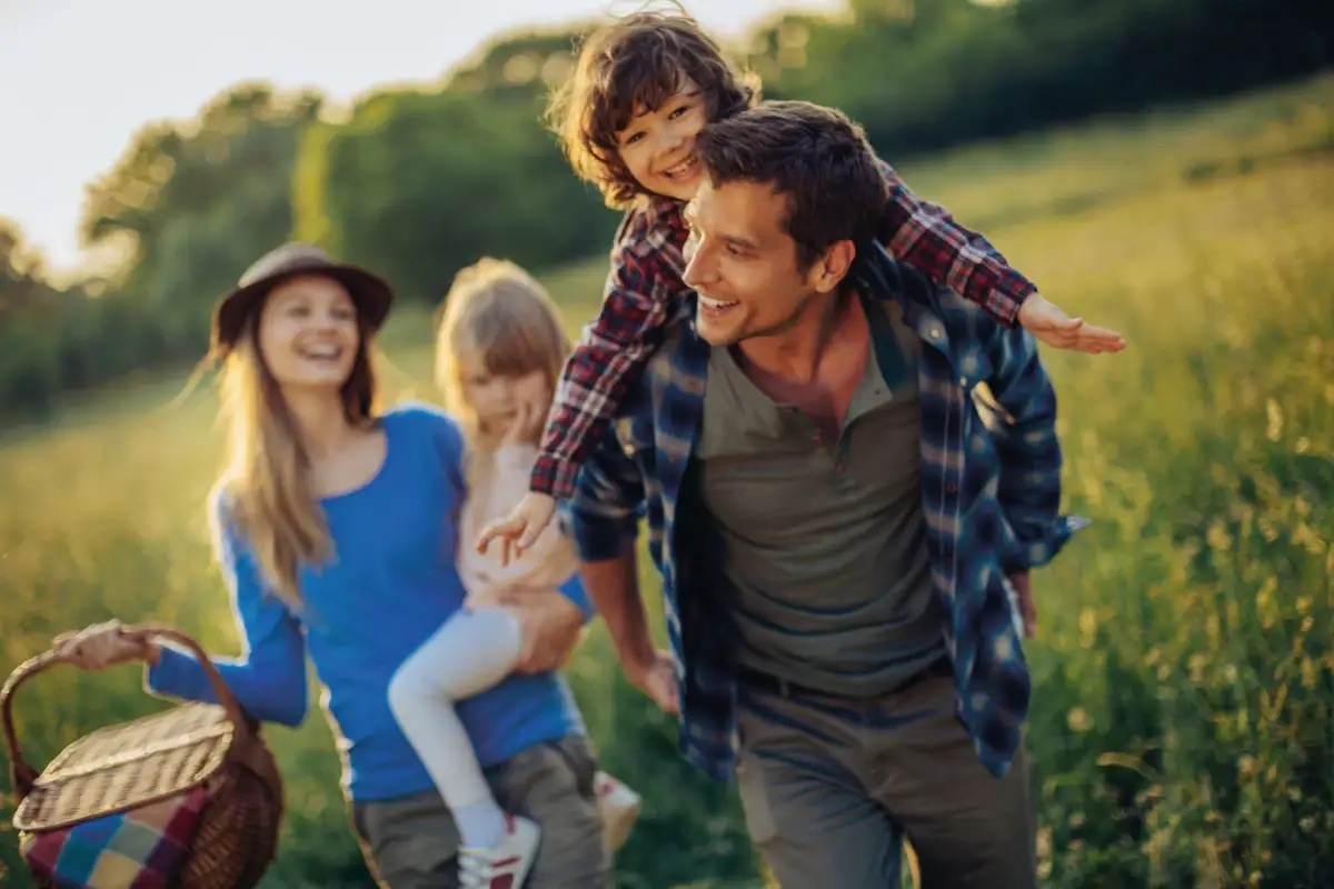 Family outing with children Usedom A man carries a child on his shoulders outdoors on a family outing.