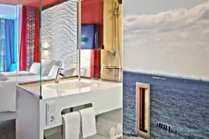 A room with a bed and a washbasin.