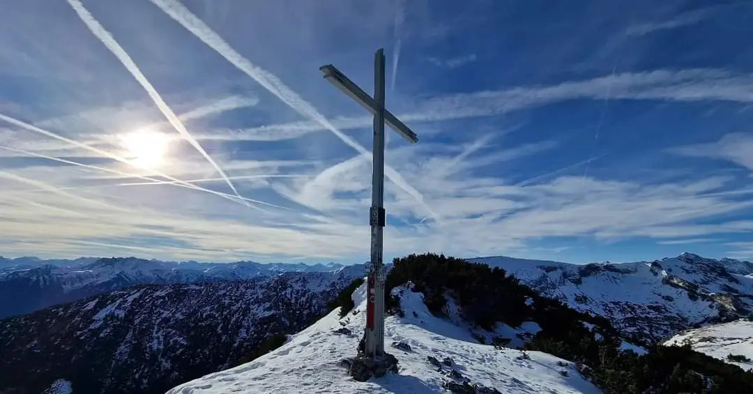  Cross on a snowy mountain peak.