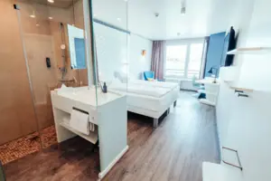 A room with two beds and a shower.