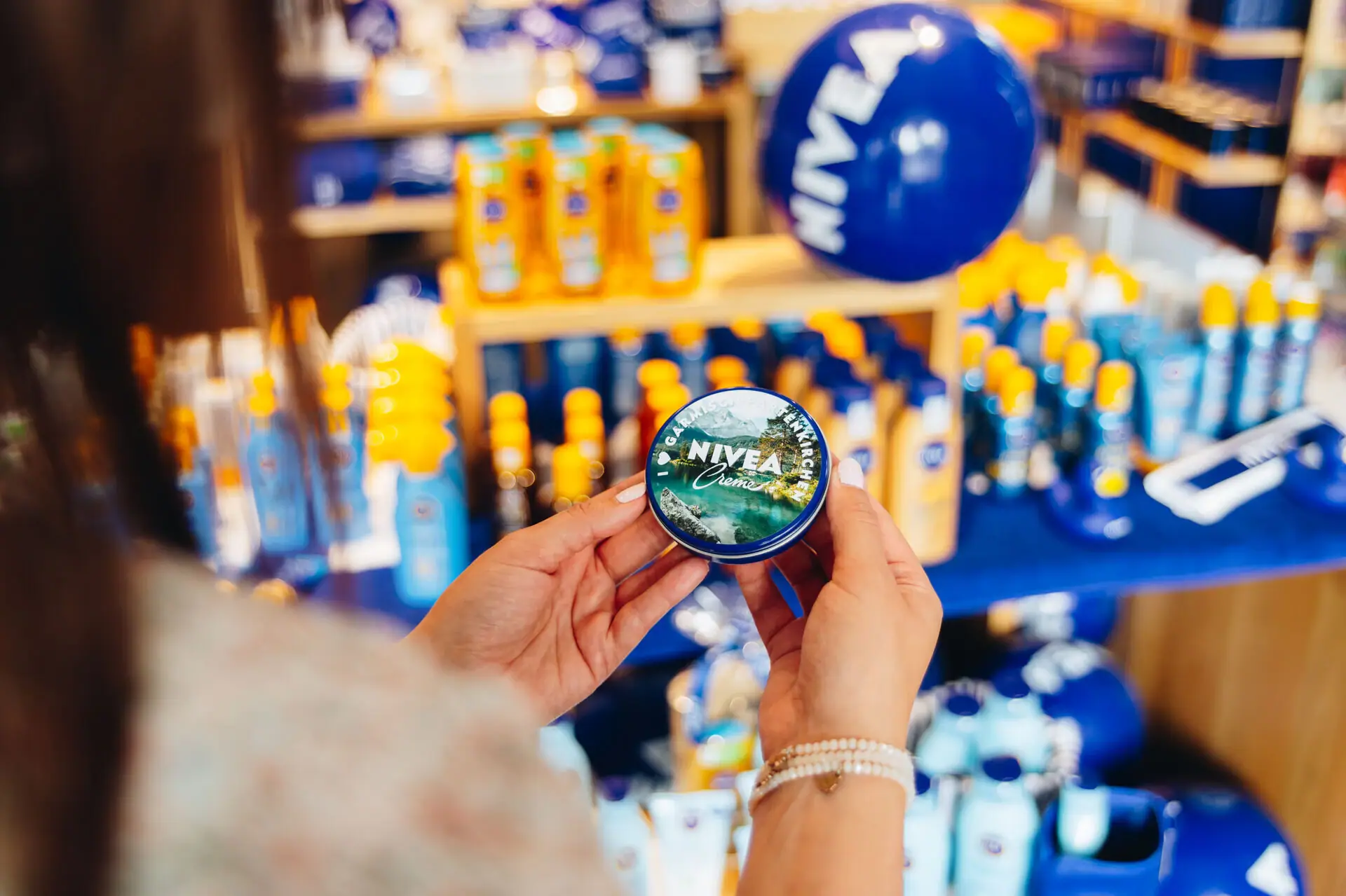 NIVEA Cream Tin One person is holding a container of cream.