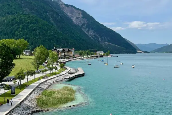 A body of water with a path and boats on it.