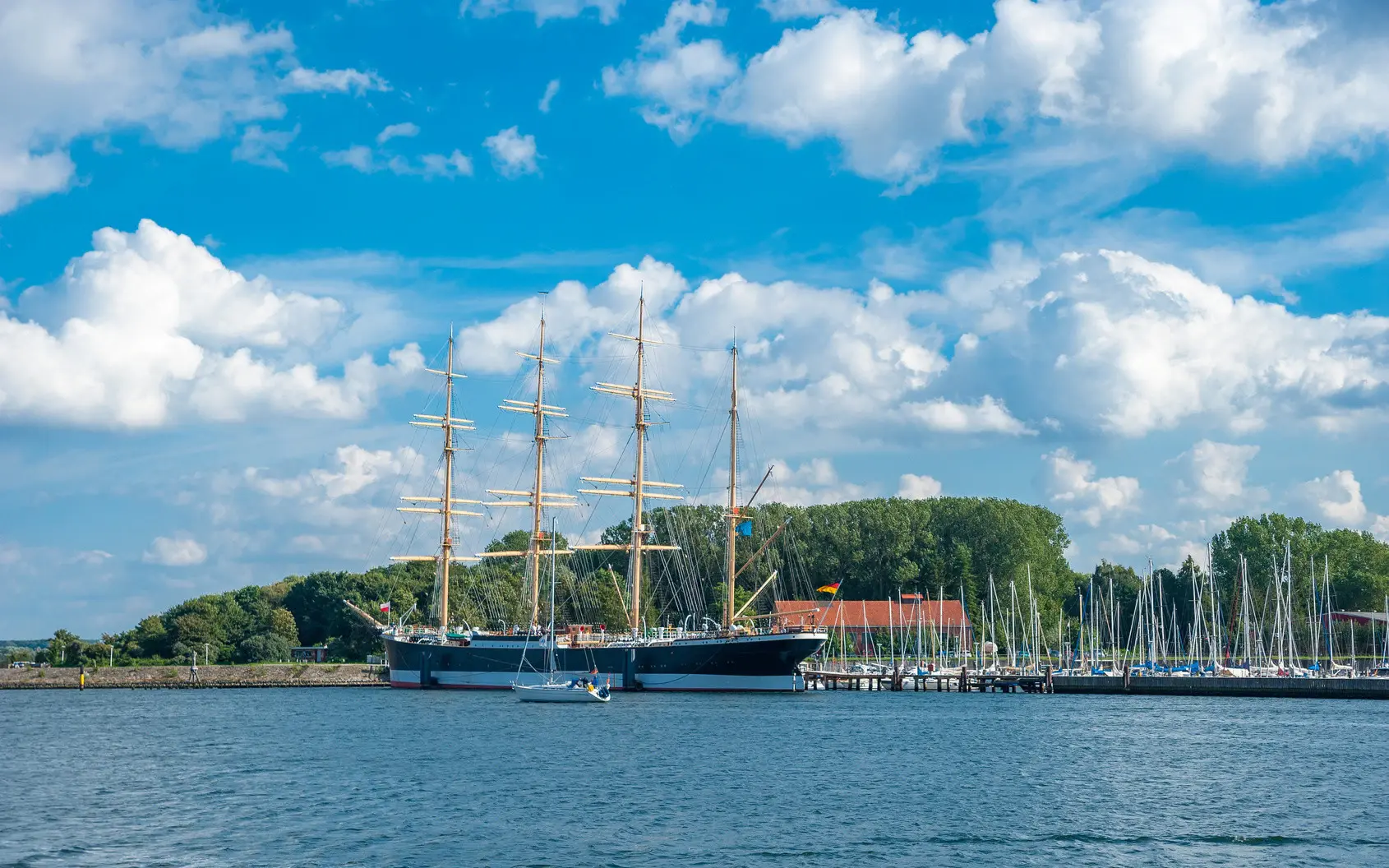 A large ship floats on blue water