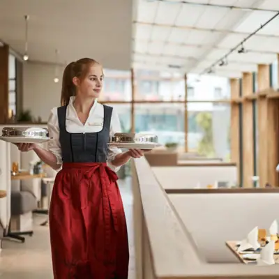 A woman holds two plates.