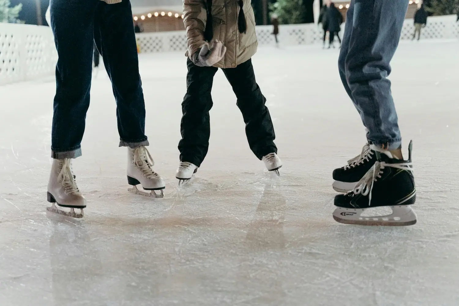 A group of people ice skating.