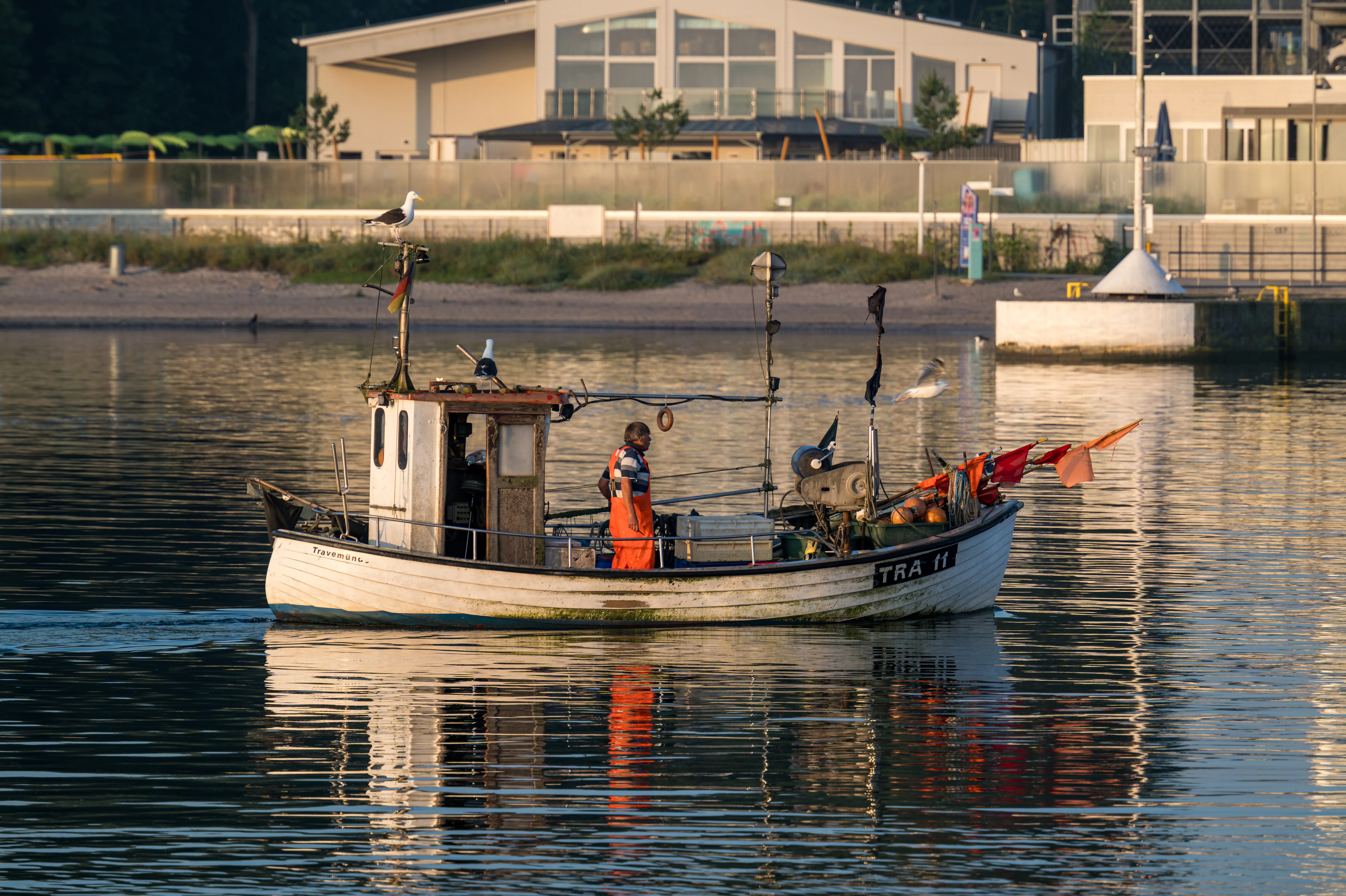 Fisherman on a small fishing boat on the Trave.