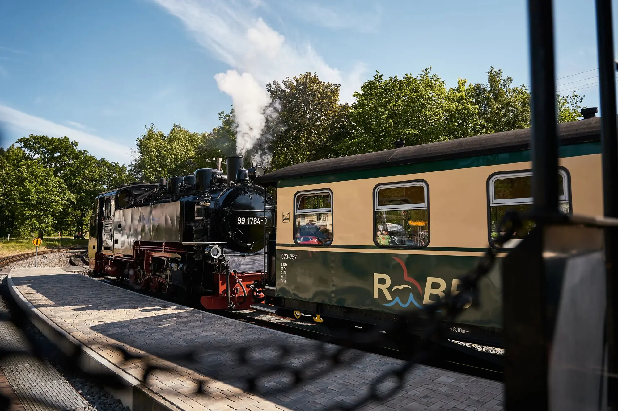 A train on the tracks in the open air.