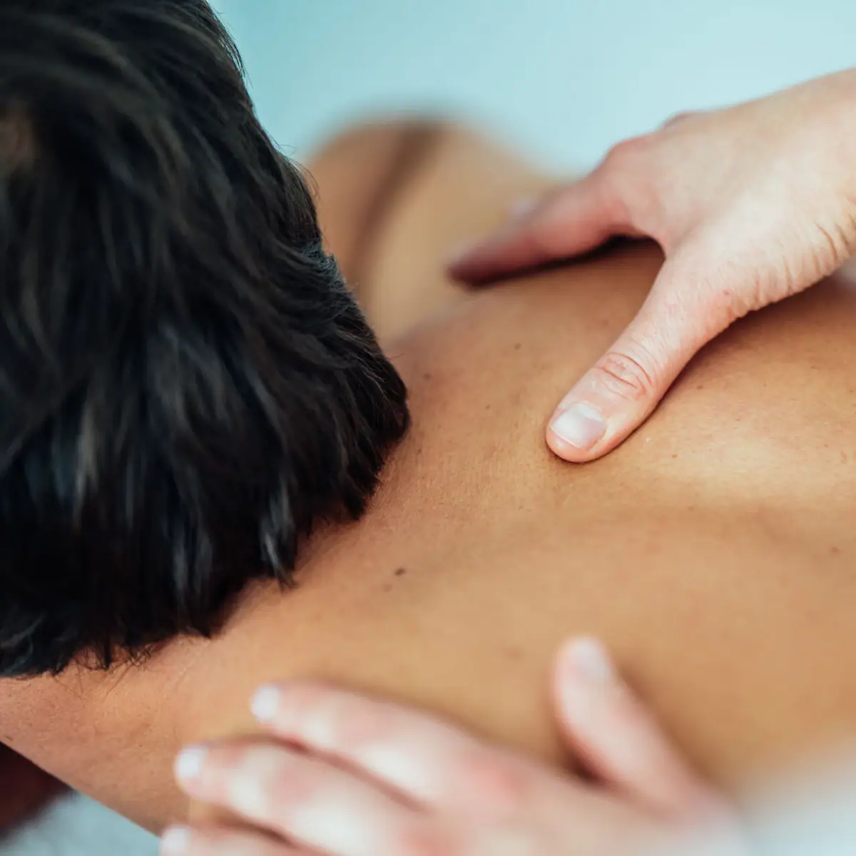 One person receives a back massage.