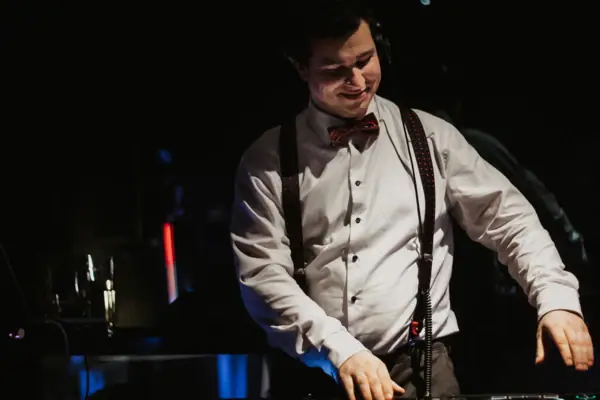 A man wears a bow tie and headphones.