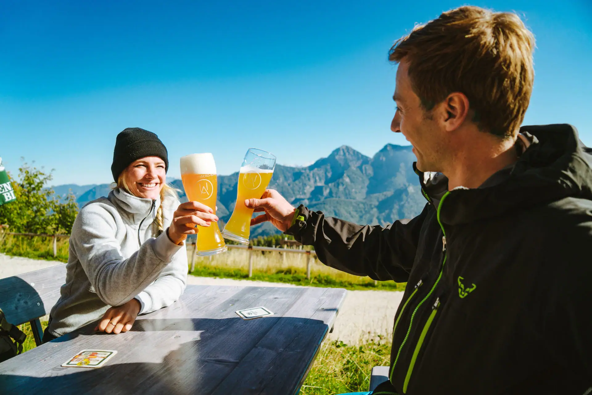 Toast with beer A man and a woman holding glasses of beer.