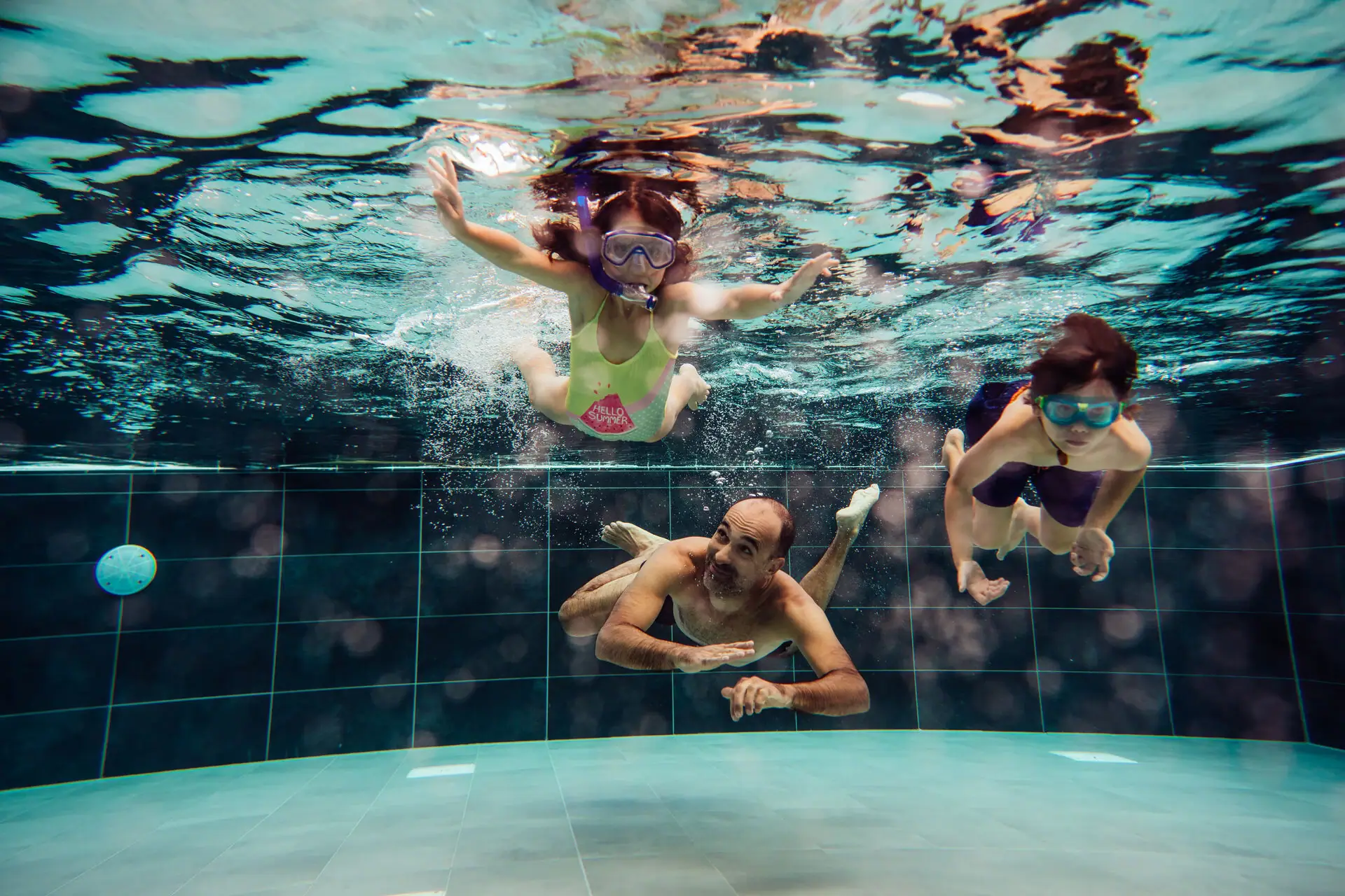 People in the pool A group of people swim under water.