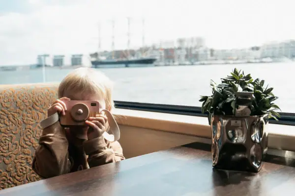 Shipping A child holds a camera.