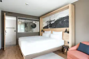 Suite mountain view A bed with a picture above it.