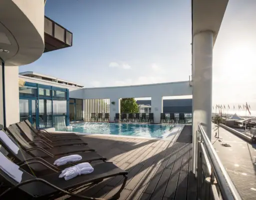 Pool with sun loungers and outdoor deck