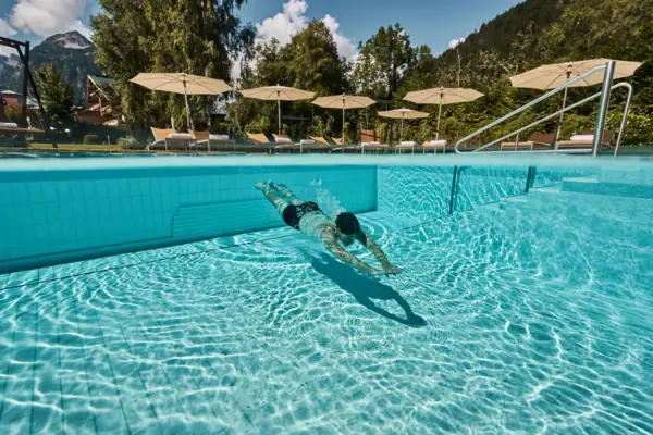 A person swims in a pool.